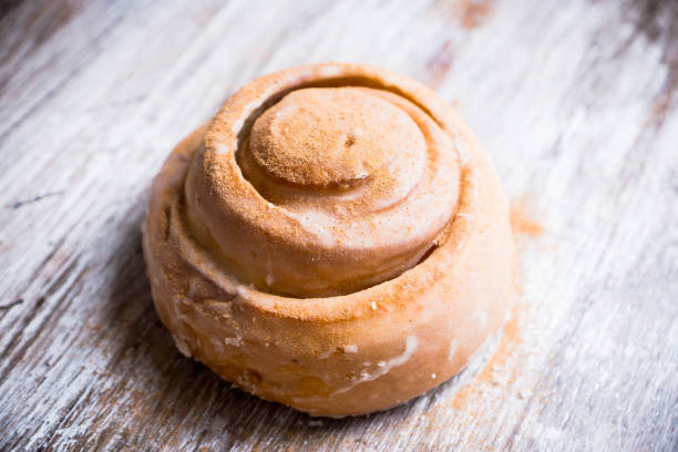 Cinnamon bun on the wooden background