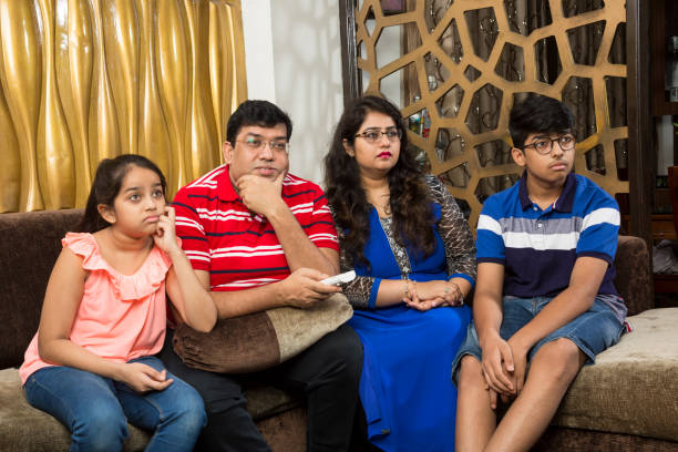 istock Family sitting together watching tv 1137738049