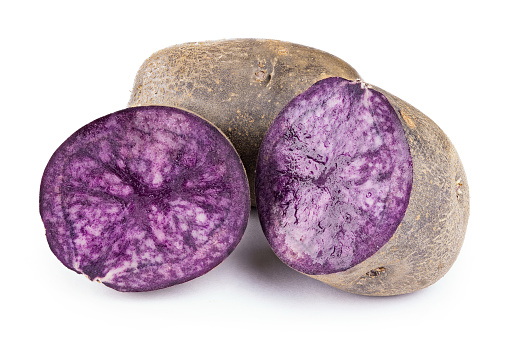 purple potato isolated on white background. place for text. the potatoes are cut. clearly visible texture of potatoes in the cut