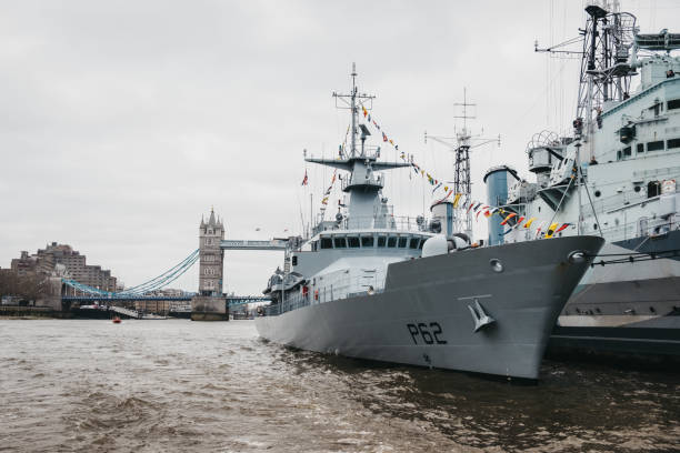 London, UK - March 16, 2019: View of HMS Belfast and another ship from River Thames. HMS Belfast most significant surviving Second World War Royal Navy warship that is now a museum moored in London.