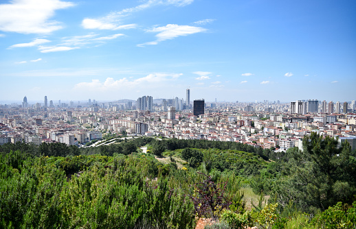 Panoramic wide shot of Istanbul's rapidly developing neighborhoods on the Asian side of the city, as seen from a beautiful hillside park near Ataşehir - Istanbul, Turkey