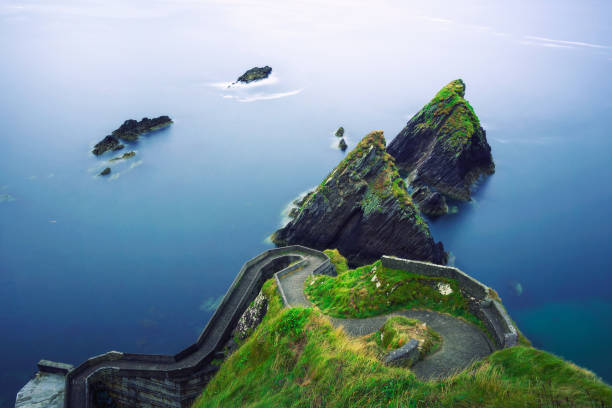 Staircase leading to the Dunquin Pier in Ireland Staircase leading to the Dunquin Pier situated on the west coast of the Dingle Peninsula in Ireland. Long exposure. dingle bay stock pictures, royalty-free photos & images