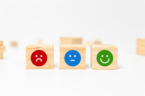 smiley face on wood block cube - business services rating customer experience, Satisfaction survey concept - Feedback