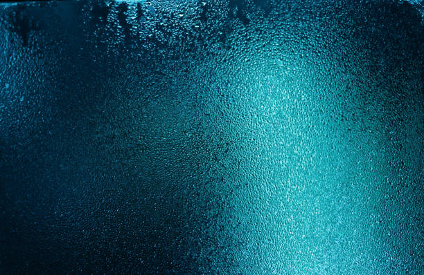 istock blue water drops on wet glass with highlights 1137744472
