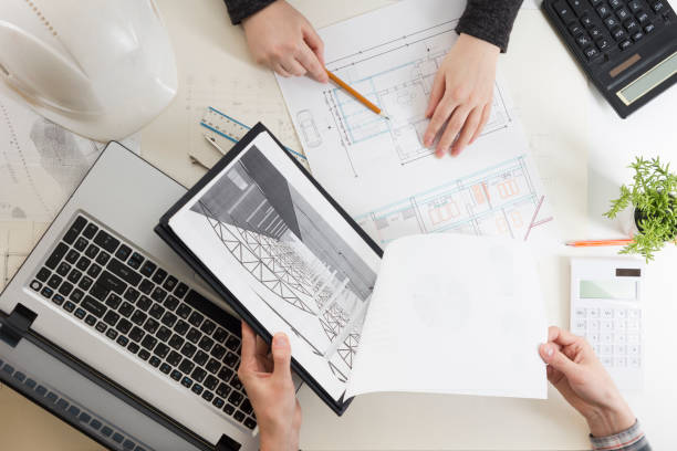 architects working on blueprint, real estate project. architect workplace - architectural project, blueprints, ruler, calculator, laptop and divider compass. construction concept. engineering tools. - housing project organization meeting real estate imagens e fotografias de stock