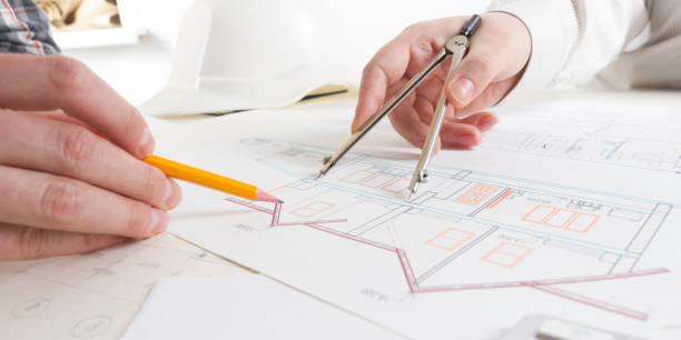 architects working on blueprint, real estate project. architect workplace - architectural project, blueprints, ruler, calculator, laptop and divider compass. construction concept. engineering tools. - housing project organization meeting real estate imagens e fotografias de stock