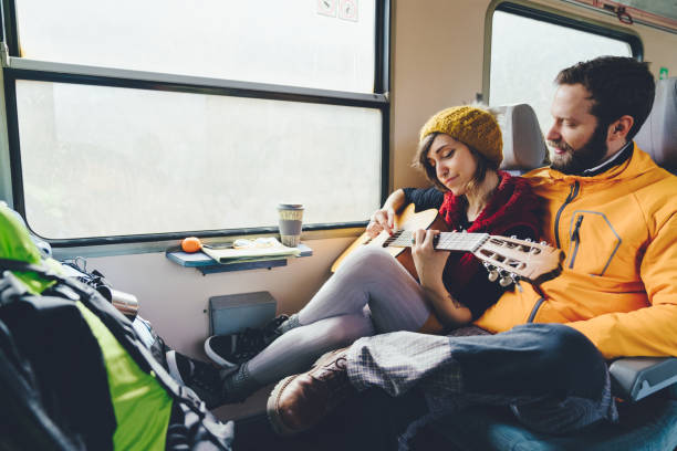 istock Couple playing the guitar in train 1137751521