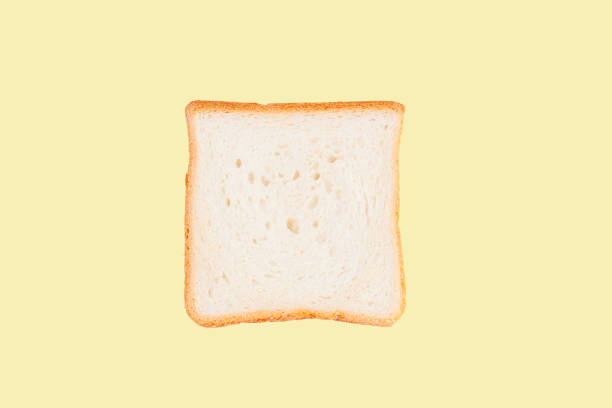 Single slice of toast bread isolated on yellow background