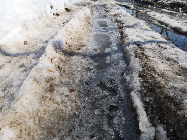 istock Winter melting snow on the road closeup, early spring 1137754100