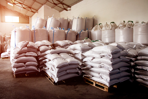 Abstract agrarian image with bags of grain in the agricultural sector in the farm. (good harvest, abundance - concept)