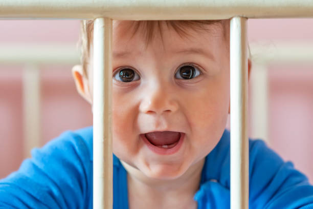 istock Baby boy in his crib 1137758424
