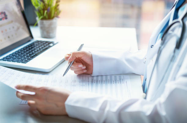 istock Doctor examining medical report 1137759921