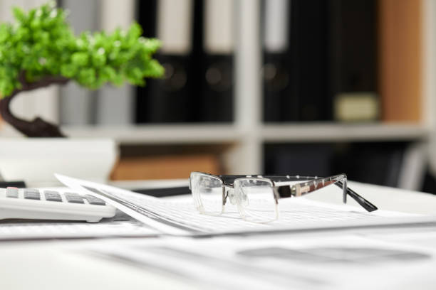 Office interior, closeup table with reports. Business financial accounting concept.