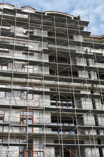 istock new building under construction, scaffolding and concrete 1137760781