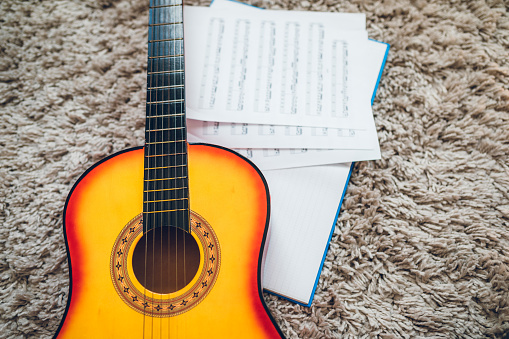 Acoustic guitar and sheet music