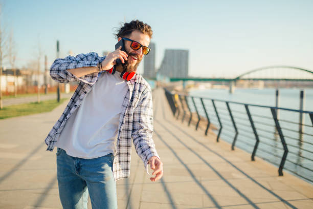 istock Man walking next to the river with phone 1137763049