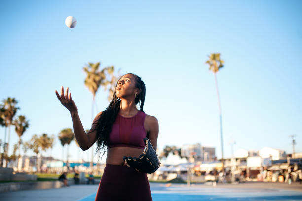 young woman practicing baseball near venice beach, california - playing catch imagens e fotografias de stock