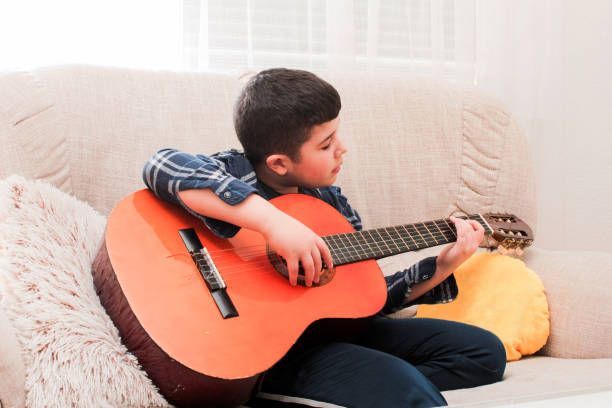 istock The boy is playing the guitar 1137767063