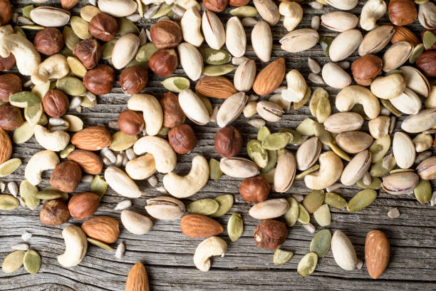 istock Mix of nut on a wooden background, top view 1137769067