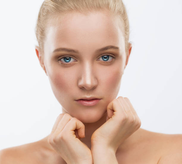 istock Face, serious, hands, blue lenses, close up, white background 1137769735