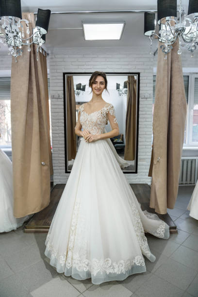 istock Bride in wedding dress posing with hands on waist 1137771774
