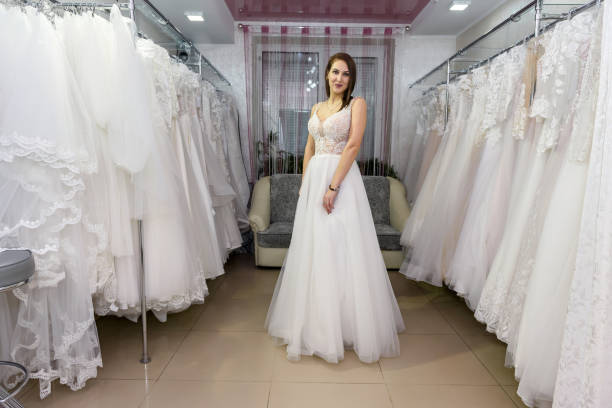 istock Happy bride in wedding dress standing in salon 1137771843
