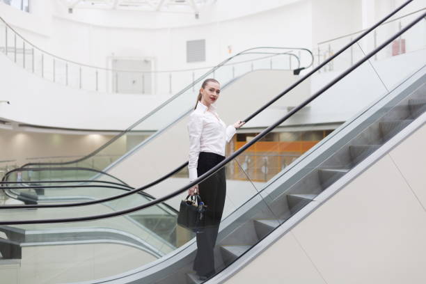 istock Business suit, handbag, escalator + 1137772505