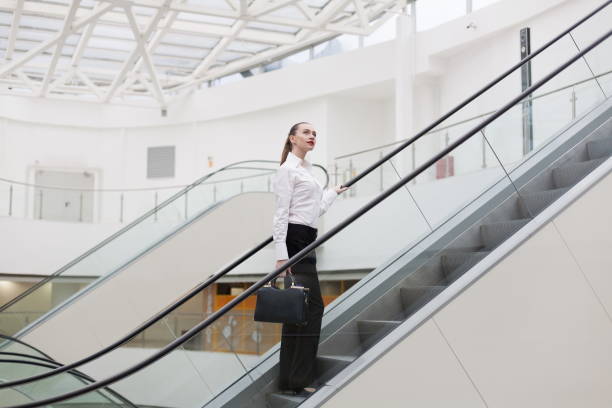 istock Business suit, handbag, escalator + 1137772598