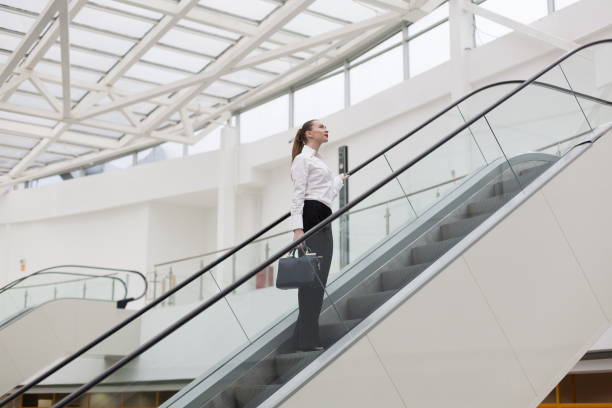istock Business suit, handbag, escalator + 1137773105