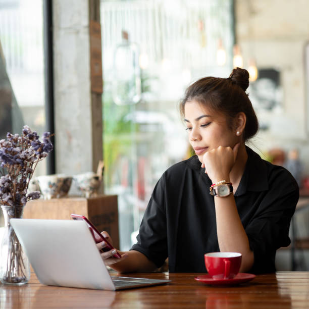 istock Asian woman working in cafe and using smart phone. 1137773134