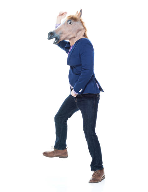 istock Businessman with horse mask is dancing 1137773137