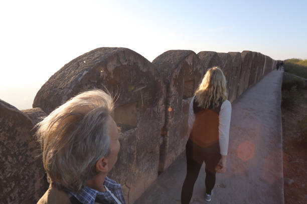 istock Couple explore ancient walls at sunrise 1137773316