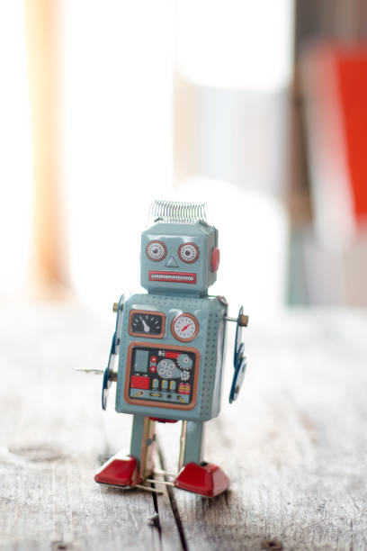 istock Robot toy, symbol for a chatbot or social bot and algorithms. Wood texture. 1137773725