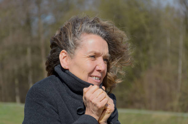 istock Woman snuggling into her jacket on a windy day 1137773885