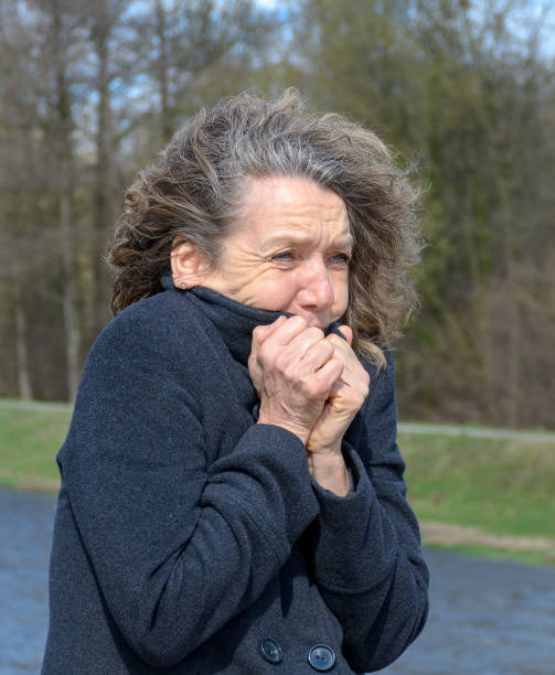istock Woman snuggling into her jacket on a cold day 1137774725