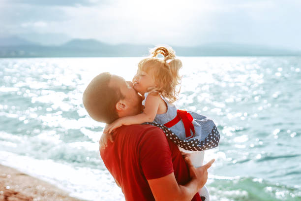 istock dad picks up the child 1137777024