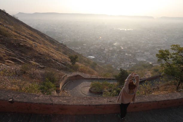 istock Woman stops to stretch on pathway above Jaipur 1137779636