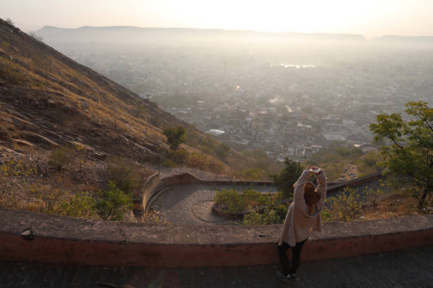 istock Woman stops to stretch on pathway above Jaipur 1137779792