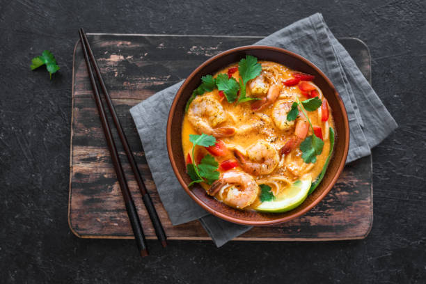 Laksa Shrimp Soup Laksa Shrimp Soup. Prawn noodle laksa soup on black background, top view, copy space. Asian Malaysian food. prawn seafood stock pictures, royalty-free photos & images