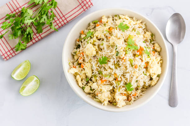 Chinese Style Egg Fried Rice Chinese Style Egg Fried Rice with Vegetables and Cilantro High Angle View / Directly Above Photo. Fried Rice, Comfort Food, Oriental Cuisine Concept. fried rice stock pictures, royalty-free photos & images