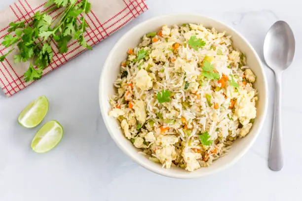 Chinese Style Egg Fried Rice with Vegetables and Cilantro High Angle View / Directly Above Photo. Fried Rice, Comfort Food, Oriental Cuisine Concept.