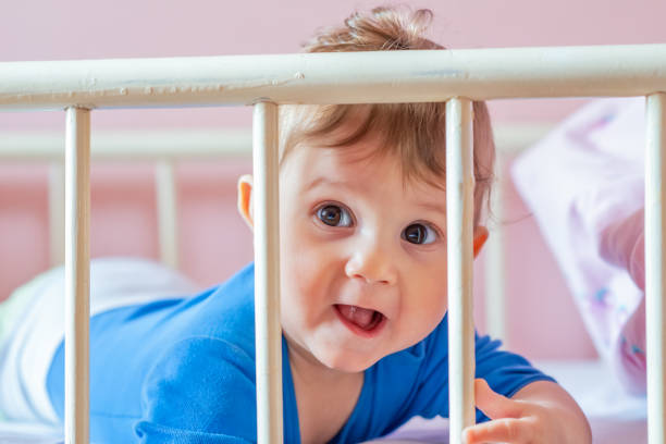 istock Baby boy in his crib 1137781623