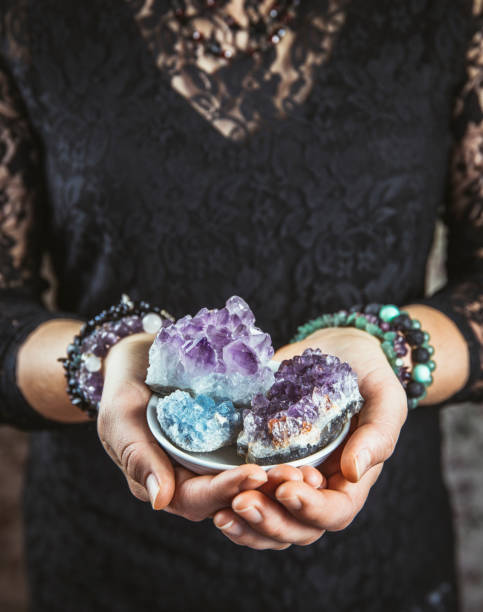 istock Healer woman holding different crystal clusters( amethyst, celestite) in palms hands. Close up view, using working with crystals concept. 1137783521