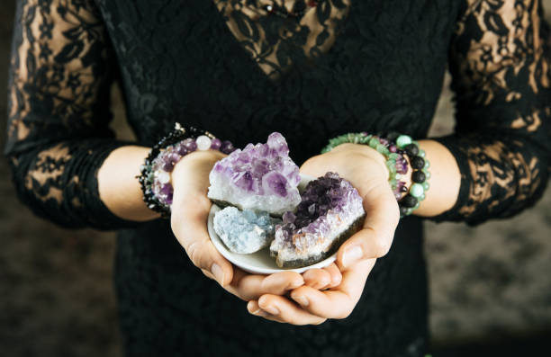 istock Healer woman holding different crystal clusters( amethyst, celestite) in palms hands. Close up view, using working with crystals concept. 1137783534
