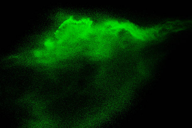 istock Green dust particles explosion on black background. Color powder dust splash. 1137784841