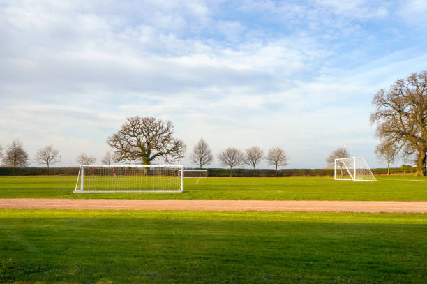 istock Empty football goalposts in playing fields on a summer morning, 1137786161