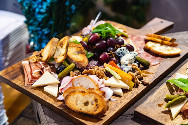 istock Appetizers table with Assorted Cheeses Fruits Nuts and Italian Antipasti Snacks. Brushetta or authentic traditional spanish tapas set, cheese variety board over grey concrete background. 1137787790