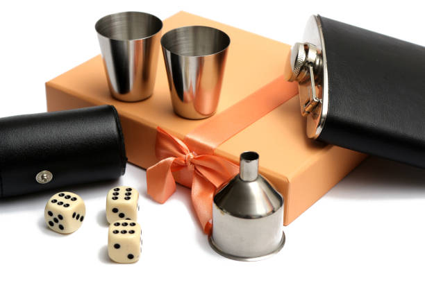 three cubes and small leather bottle with two metal tow at orange giftbox