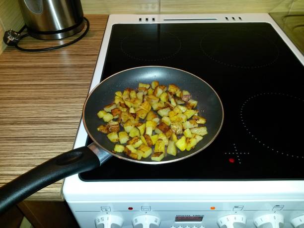 istock Roasting potatoes on a pan, on a cooker, on a ceramic hob 1137789537