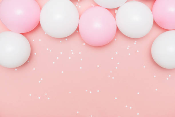 istock Pastel balloons and white confetti on pink background 1137789961